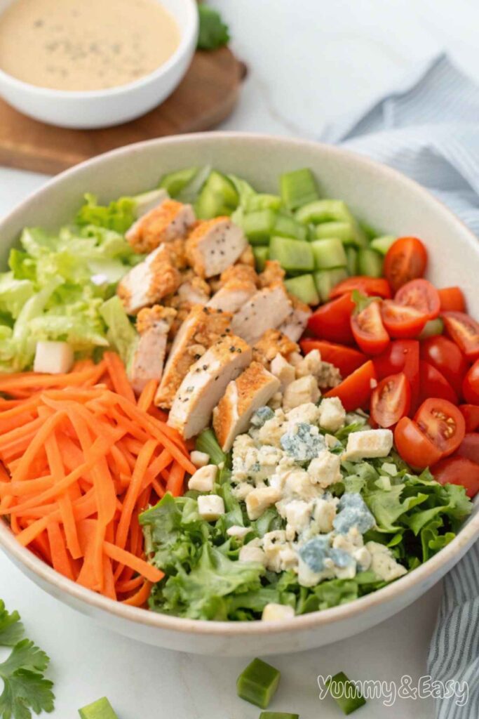 Fresh Buffalo Chicken Salad with colorful veggies and dressing.